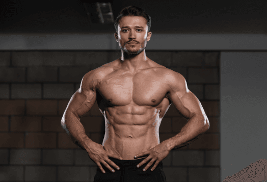 Muscular man posing in a gym