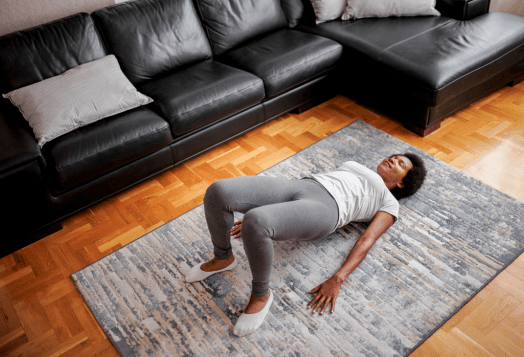 Woman doing hip thrusts on a rug