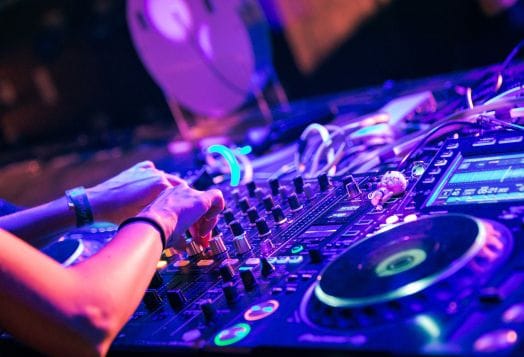 DJ mixing music on a soundboard