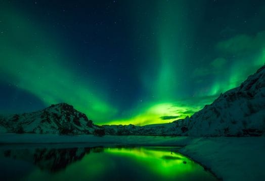 Green Northern Lights over Icelandic landscape