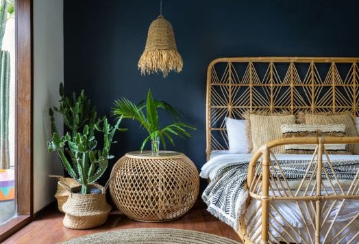 Bohemian bedroom with rattan furniture and plants