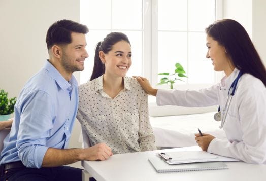 Couple consulting doctor for conception advice