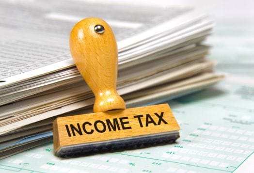 "INCOME TAX" rubber stamp on tax forms