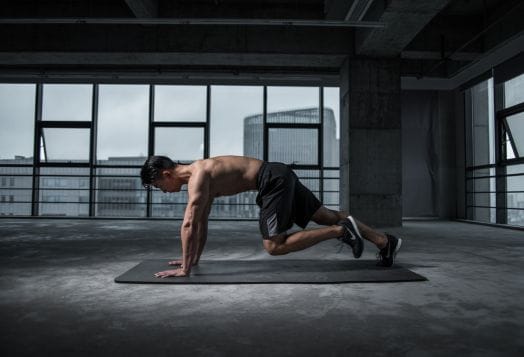Man doing mountain climbers on exercise mat