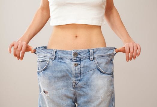 Woman in oversized jeans, weight loss