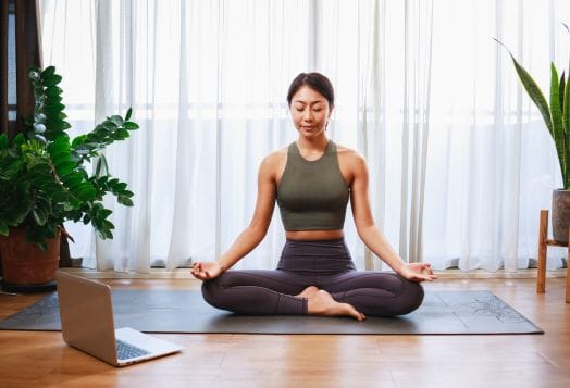 Woman practicing Hatha Yoga for beginners at home