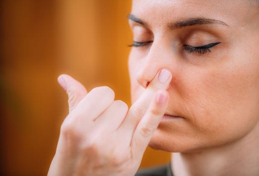 Woman practicing Nadi Shodhana pranayama breathing