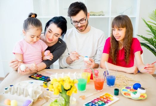 Family painting Easter eggs together