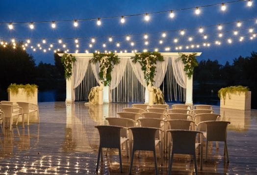 Outdoor wedding with string lights and elegant decor