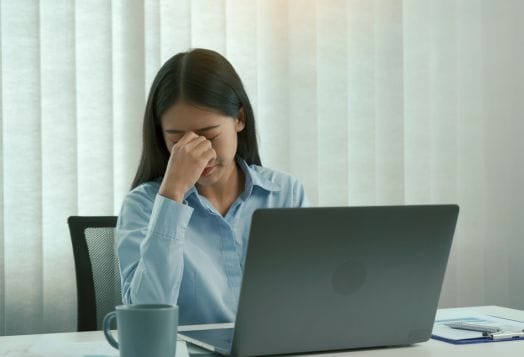 Stressed employee showing signs of burnout at workplace
