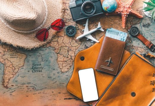 Travel items on a world map background