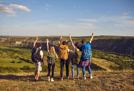 Group of hikers celebrating scenic view
