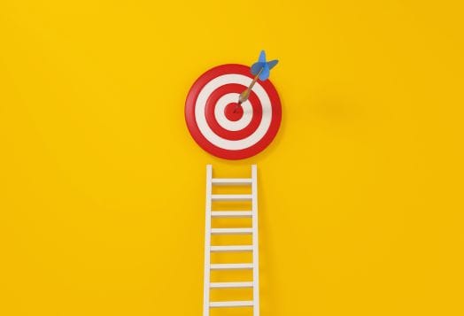 Ladder reaching target symbolizing retreat objectives