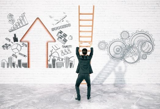 Businessman climbing a ladder towards success