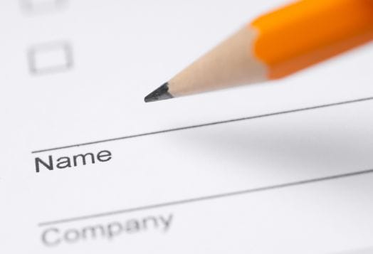 Pencil about to write "Name" on a form
