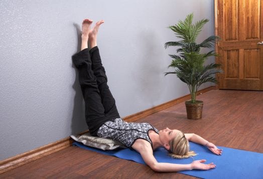 Woman doing Legs Up the Wall for yoga relaxation