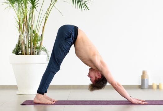 Man in Downward-Facing Dog pose for flexibility exercise