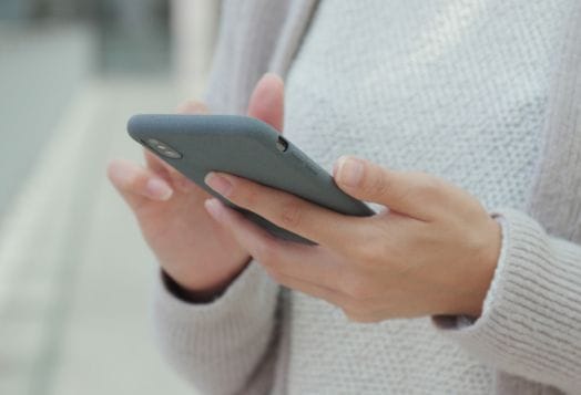 Hands holding and using a smartphone