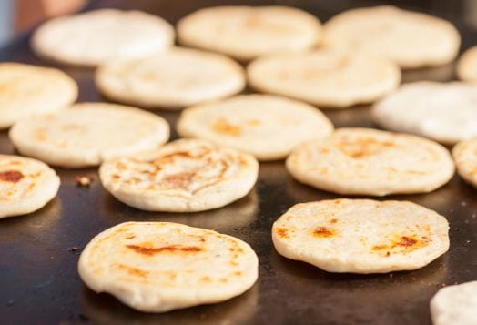 Mini rotis cooking on a hot griddle, rich in fiber and nutrients