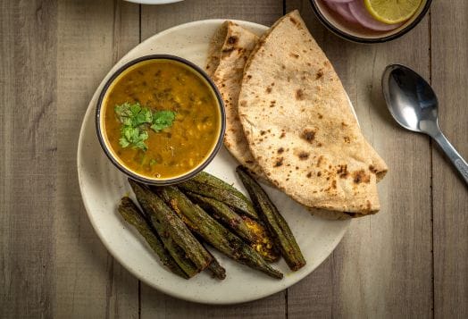 Plate of dal, roti, and okra, a balanced Indian meal