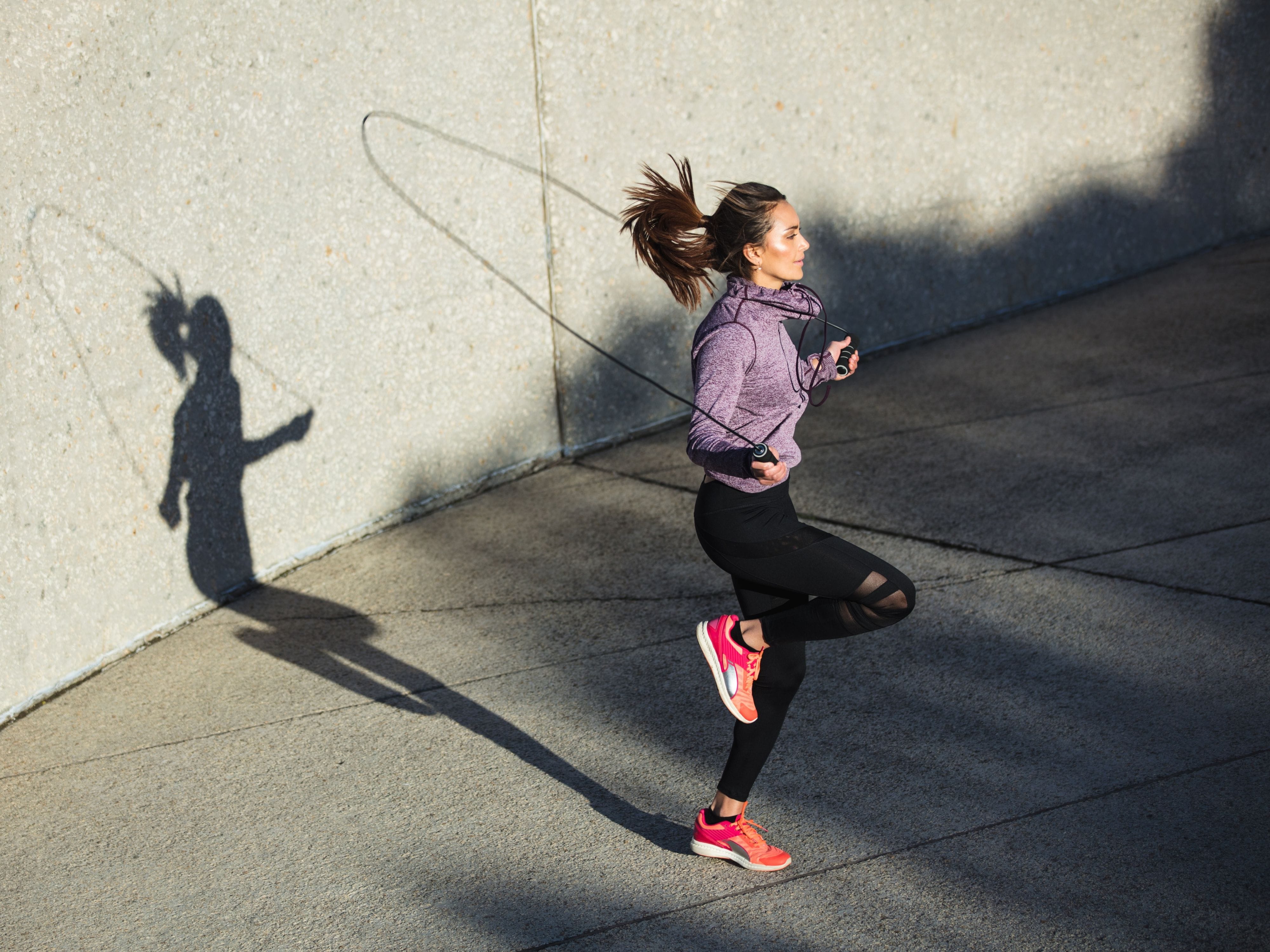 Woman jumping rope outdoors