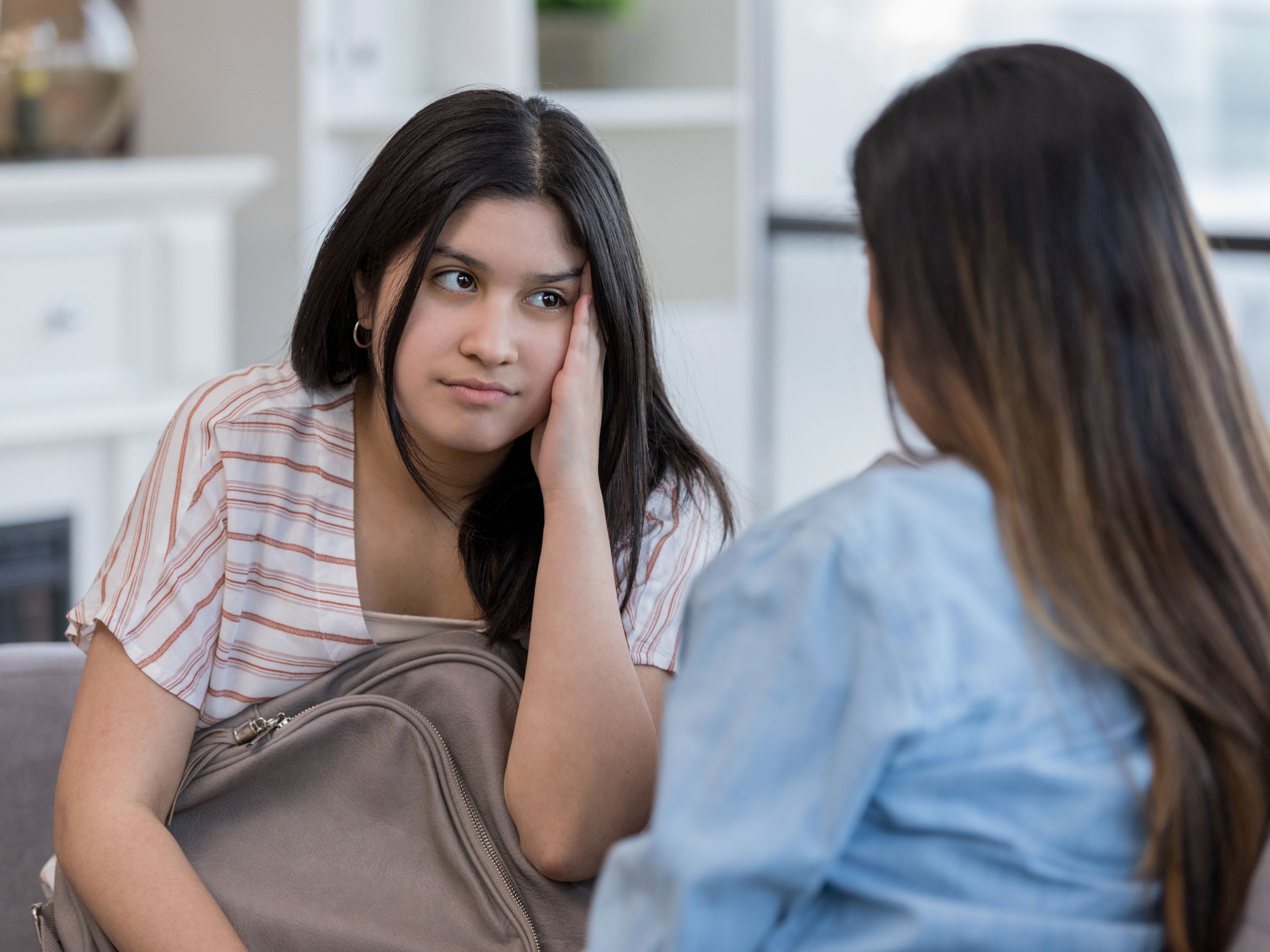 Teenager looking away during conversation