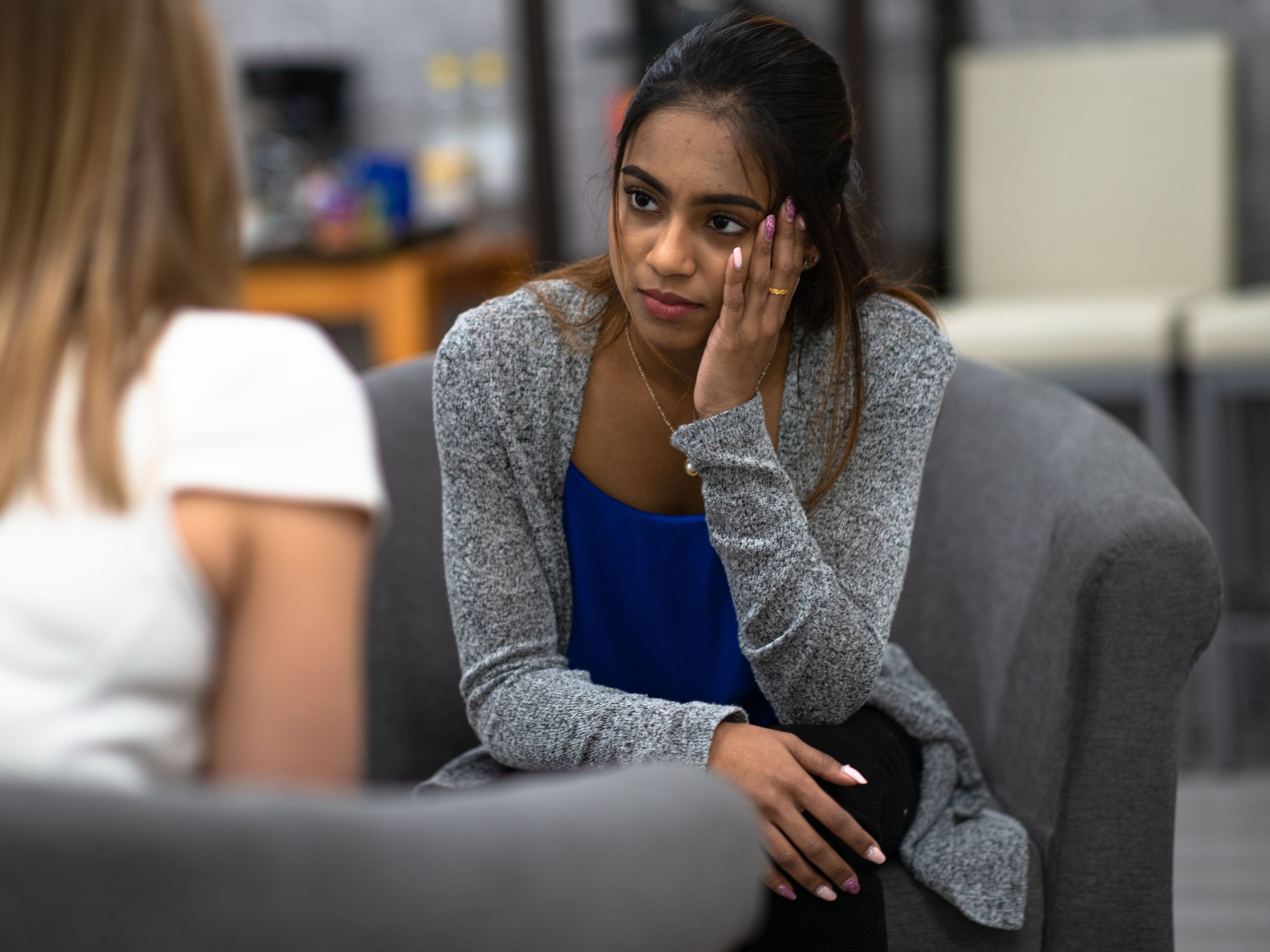 Woman listening to therapist on couch