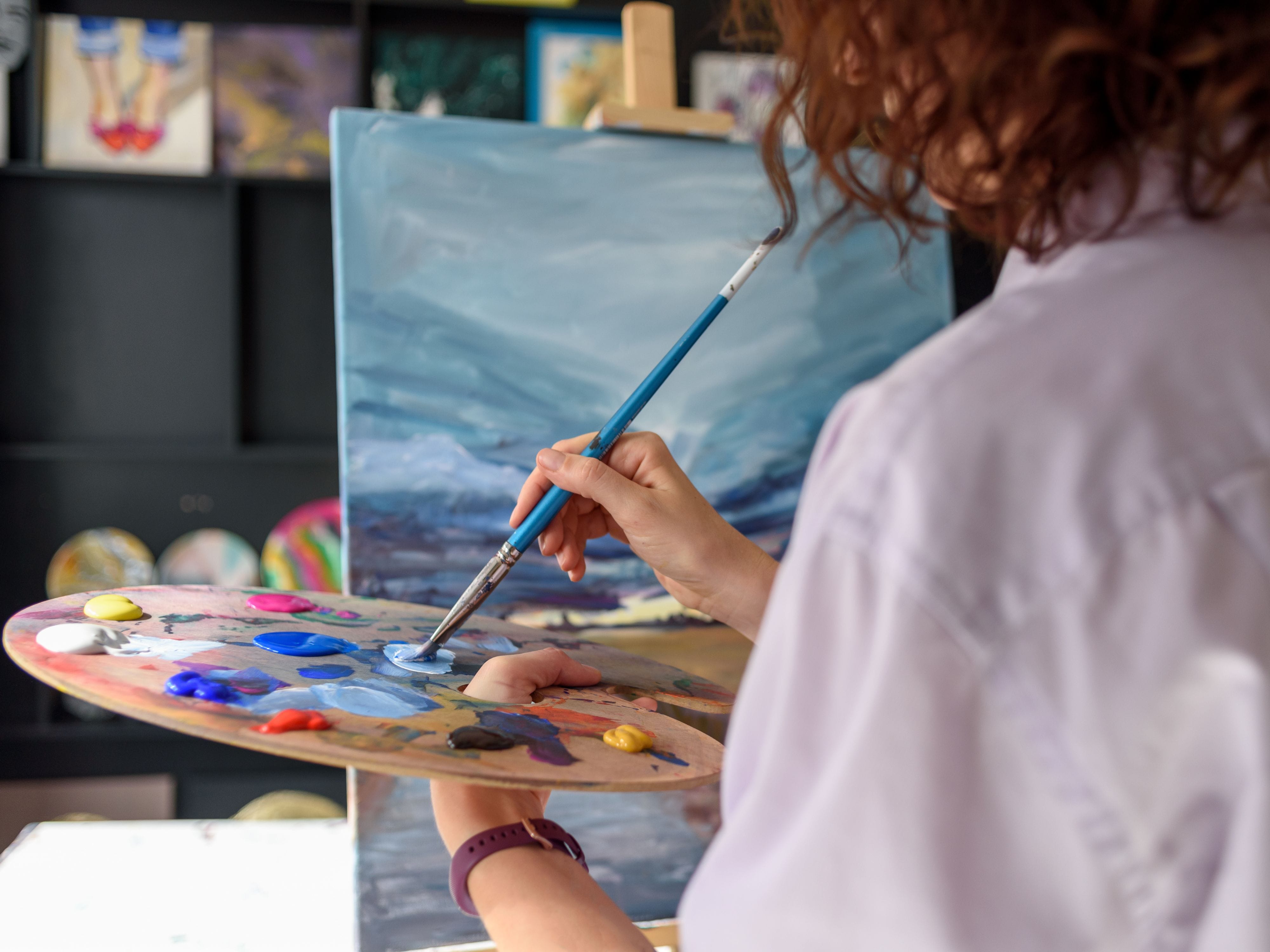 Artist painting modern art for an art exhibition