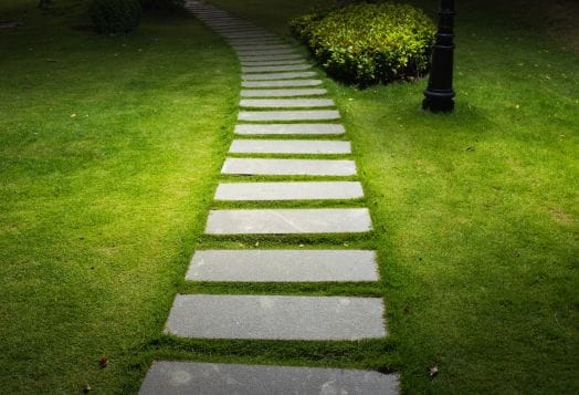 Illuminated stone garden path at night