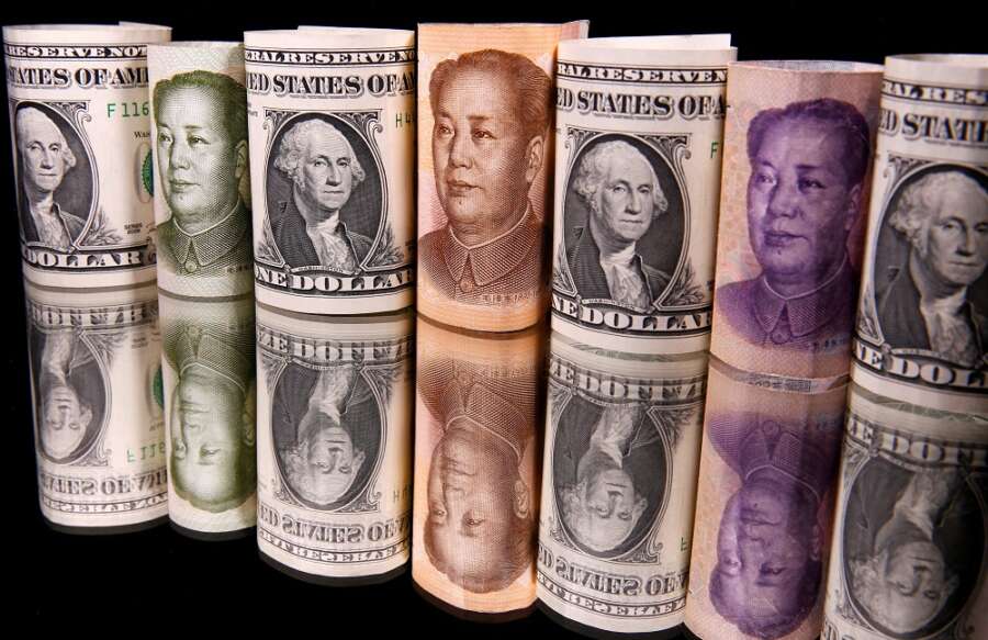 Dollar edges lower as investors wait on Fed&#8217;s Powell