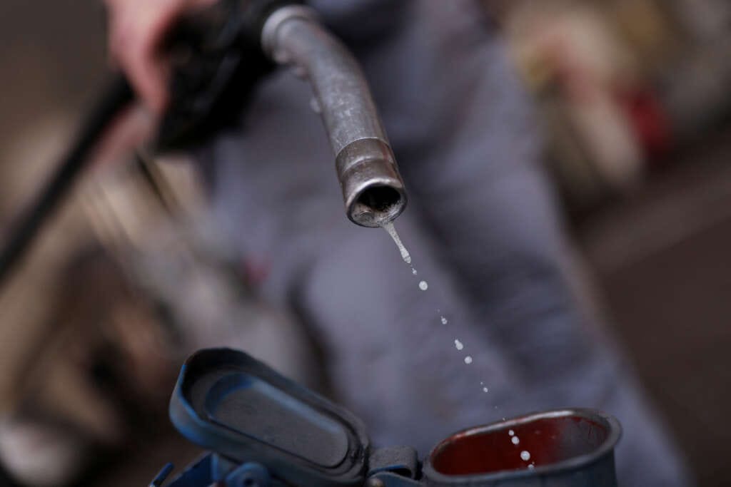 US crude oil gains on supply cuts, focus shifts to holiday demand