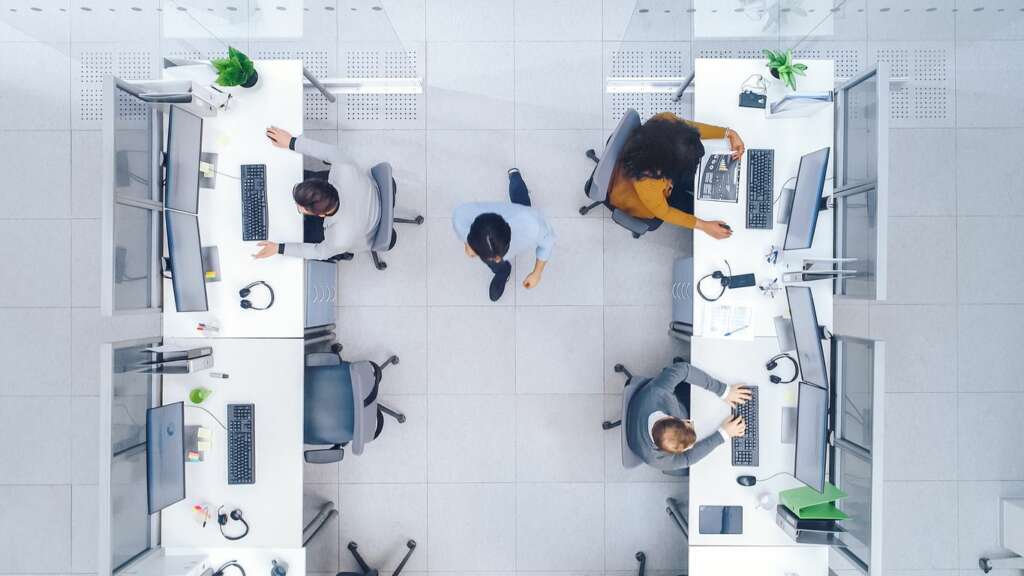 Workers resist shift to hot desks by placing personal items on workspaces, says new research