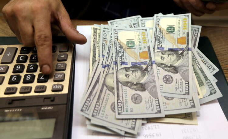 U.S. dollar climbs as new virus outbreaks threaten global outlook