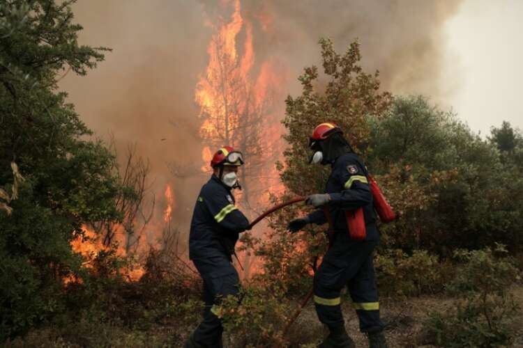 Greek villagers try to save homes as wildfires burn for eighth day