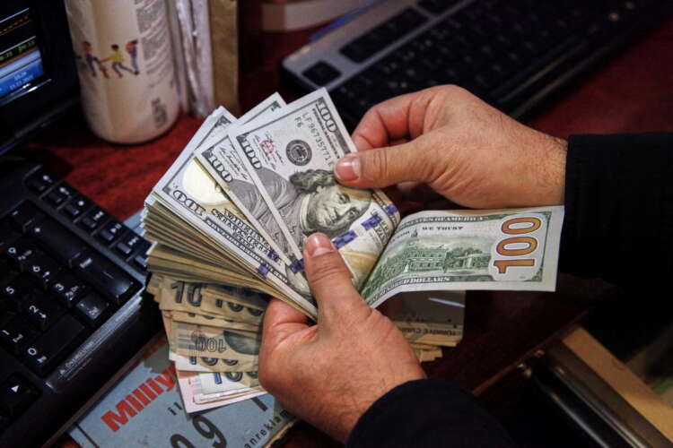 Dollar firms in soft holiday trading, outlook bullish