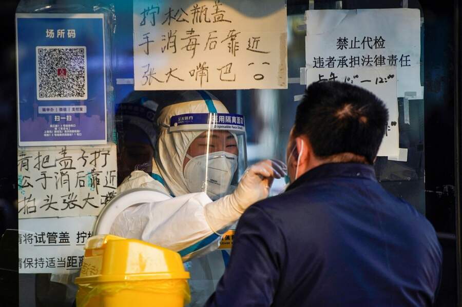 Queues form at fever clinics as China wrestles with COVID surge