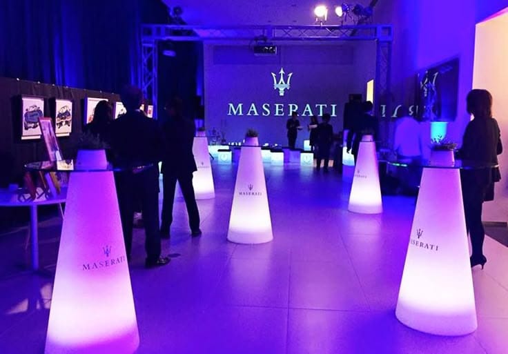 This may contain: people are standing in front of the masepatti logo at an art gallery