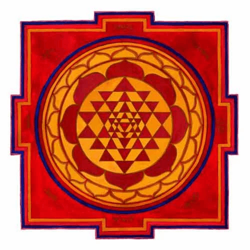 The image shows a handmade painting of the Sri Chakra Yantra. Its outer petals only have outlines while its inner petals are filled with red colour, just like the small triangles that are created by the larger interlocking triangles.