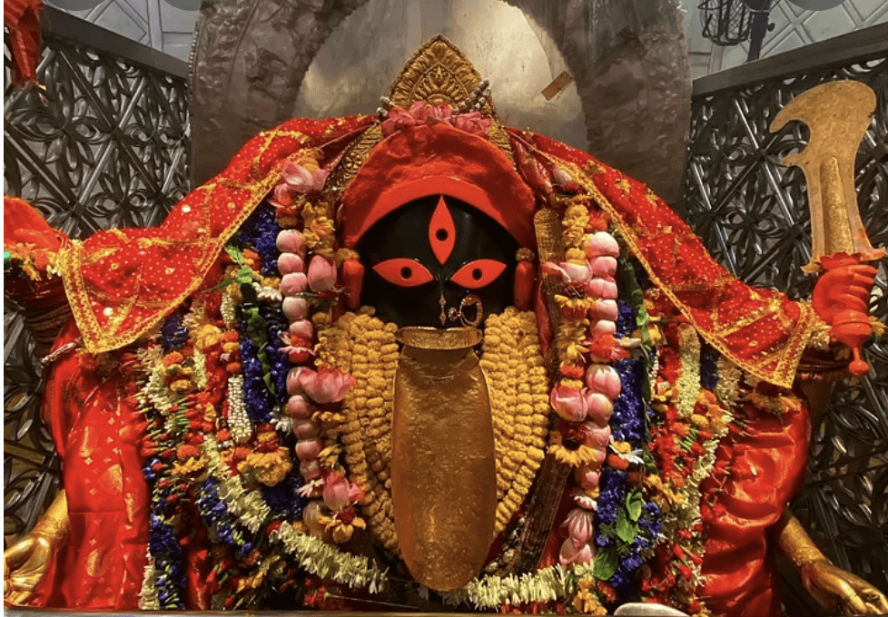 A photograph of the decorated idol of Ma Kali inside the Kalighat Temple in Kolkata.